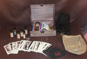lot 37 image: Lost Hollow Tarot cards and oils, candles and a wood box with lock and hidden key