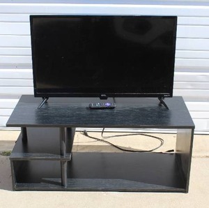 lot 79 image: 32 inch Roku TV and remote and tv stand tested worked when posted see pictures