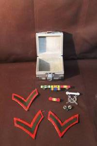 lot 268 image: vintage military insignia, including embroidered chevrons (likely rank patches) and medal ribbons.