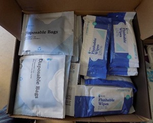 lot 76 image: disposal bags and flushable wipes