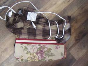 lot 182 image: heating pad and folded luggage bag