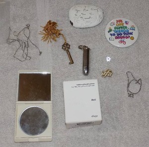 lot 76 image: MISC JEWELRY PINS, KEYCHAIN, COMPACT, PIN BACK, ROCK, LAGGO- HOOPS LV