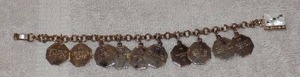 lot 79 image: CHARM BRACELET - 10 COMMANDMENTS W BIBLE CLASP