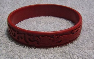 lot 277 image: VINTAGE CINABAR CARVED BRACELET