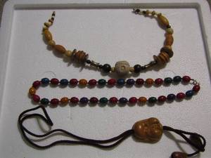 lot 215 image: WOOD BEAD NECKLACES X 2 AND JAPANESE CARVED FACE BOLO TIE