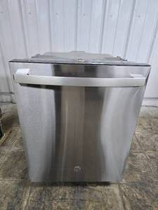 lot 77 image: GE 24 Built-In Stainless Steel Dishwasher.  Front panel has damage