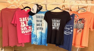 lot 85 image: Six (6) Womens Graphic T-Shirts &amp Ball Cap in a Variety of Sizes