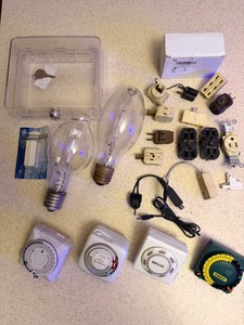 lot 210 image: Assorted Electrical Supplies - Including Light Timets, New Constant Voltage Controller, Outlets, Adapters,Locking Thermostat Covers, Mercury Vapor Lights