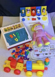 lot 225 image: Vintage &amp Memorable Childrens Toys - Including&nbsp12 1984 FisherPrice Plush CRIB FRIENDS GIRL Pink Rag Doll, 1978 Tupperware Toys Build-a-Train Take Apart Pull Toy, Fisher Price School Days Desk