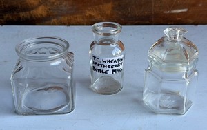 lot 255 image: KIG Clear Glass Apothecary Jar,&nbspT. C. Wheaton Apothecary Bottle (1940s), &amp Clear Glass Apothecary Jar