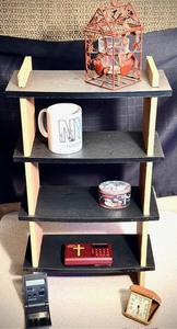 lot 299 image: Hanging or Freestanding Curious Shelf WContents - Including Hanging Wrought Iron Tea Lite Candle Holder,Wonder Bible, Travel Alarm Clocks, &amp More