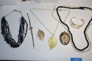 lot 88 image: Gold leaf pendants, black and white opera length necklace, womens watch and more