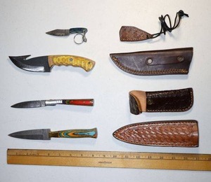 lot 101 image: Damascus steel knives Hunting knife, dagger, folding pocket knife and key chain knife