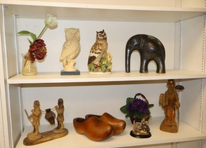 lot 161 image: Home decor owl figurines, metal elephant figurine, wood clogs, wood Moses statue with 10 commandments, and flowers