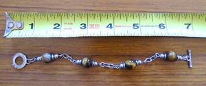 lot 274 image: $$$ P.B. .925 STERLING CATS EYE STONE AND STERLING SILVER BRACELET