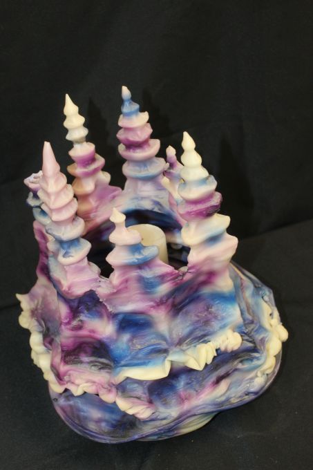 lot 111 image: Handmade Cotton Candy colored Castle Candle featuring a refillable center candle