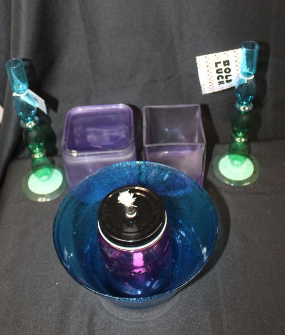lot 125 image: Colored Glass Items Cobalt Blue Bowl, Purpleblue oil lanterncanning Jar and two candle stick holders new with tags Two purple square Glass containers