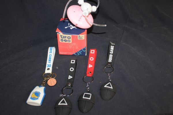 lot 189 image: Squid Games Key Chains, and Light Up Toy