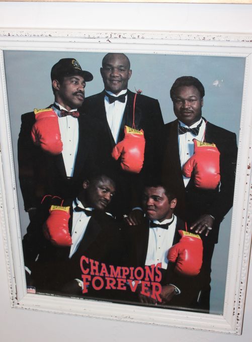 lot 19 image: Vintage poster Champions Forever Featuring boxing legends Muhammad Ali, Joe Frazier, George Foreman, Ken Norton and Larry Holmes