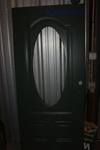 lot 316 image: Green Wooden Door with Oval Window Cut Out (no glass)