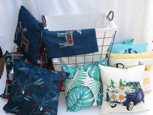 lot 40 image: Assorted accent pillows and clothing hamper as shown