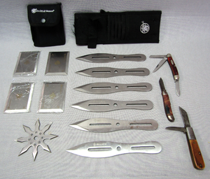 lot 55 image: Smith & Wesson Bullseye throwing knife set with sheath, Playing card throwing knives with sheath, Ninja throwing star, Two Case pocket knives plus