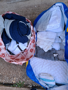 lot 221 image: Two bags of shop towels and sheets as shown