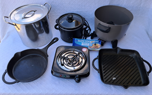 lot 194 image: Pioneer woman cast iron pans, Presto deep fryer (no lid), Walmart mini slow-cooker, single burner cooker