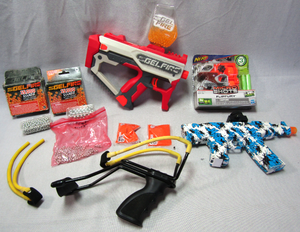 lot 110 image: Gelfire gun with ammo, Wrist rocket slingshot, and more as shown