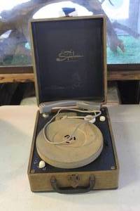 lot 70 image: vintage Symphonic portable suitcase record player powered on and table turns