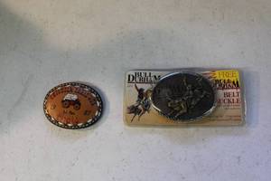 lot 73 image: vintage leather belt buckle and vintage Bull Durham Since 1871 promotional belt buckle features a cowboy riding a bull, housed in its original packaging