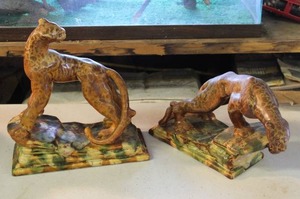 lot 86 image: a pair of vintage Royal Haeger Pottery leopards designed by Royal Hickman, often used as bookends.