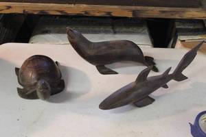 lot 99 image: vintage Mexican ironwood carvings, specifically handcrafted sea animal figurines including a sea lion, a turtle, and a shark