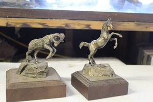lot 101 image: decorative rearing horse sculpture 172500 with signature or artist mark, and vintage sculpture of a rearing ram 56500 with signature or artist mark