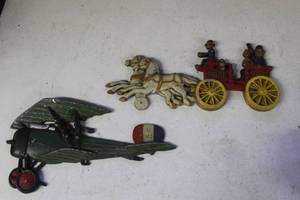 lot 103 image: vintage cast metal wall plaques of airplane and  horse-drawn fire pumper wagon
