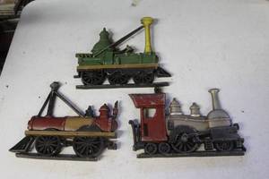 lot 104 image: vintage Sexton cast metal steam train engine wall hangings.