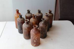 lot 113 image: antique amber glass apothecary or medicine bottles,