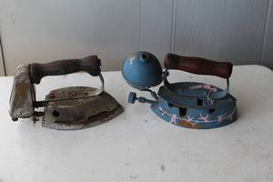 lot 124 image: vintage Coleman gas-powered clothes irons, likely dating from the 1920s to the 1940s.