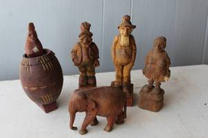 lot 182 image: vintage hand-carved wooden figurines, likely classified as folk art. The one with the barrel comes out of the barrel and  has some adult humor to it   as seen in the last picture