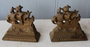 lot 187 image: cast iron bookends feature a vintage nautical design of sailing ships