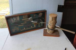 lot 200 image: decorative golf-themed memorabilia display, often referred to as a golf shadow box. And humorous collectible art piece featuring a bent golf club shaft wrapped around  a wooden log inscribed with the words I QUIT