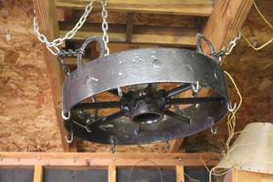 lot 256 image: rustic wagon wheel style chandelier, featuring a black wrought iron frame and hanging chain for a farmhouse or industrial aesthetic