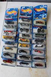 lot 275 image: collection of vintage Hot Wheels die-cast toy cars still in their original packaging. From 2000 and lower and some may have damage to package