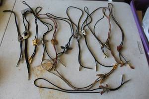 lot 296 image: collection of vintage bolo ties featuring various Western-themed metal slides