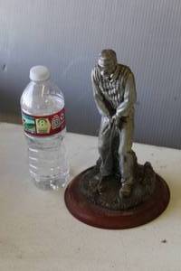 lot 358 image: Michael Garman sculpture titled Tee Shot. Water bottle in picture for size