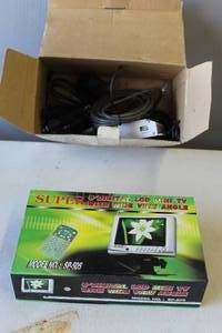 lot 424 image: Super Digital LCD Mini TV, specifically Model No. SP-505.  And a box full of other things see pictures for details