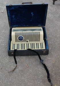 lot 439 image: vintage Wurlitzer piano accordion with a white finish, in its original hard case.