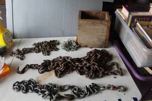 lot 453 image: Wood box full of collection of heavy-duty metal chains,