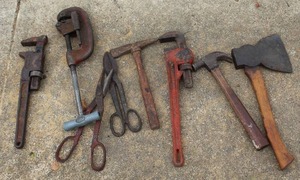 lot 515 image: collection of assorted rustic and vintage tools, including a pipe cutter, various wrenches, pliers, a hammer, and a small axe.