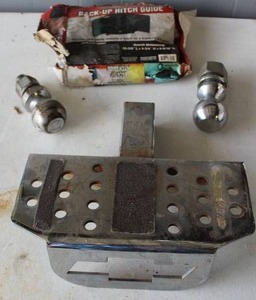 lot 567 image: metal hitch step with a Chevrolet bow-tie logo, aul-Master Back-Up Hitch Guide and trailer hitch balls   2-516 inch